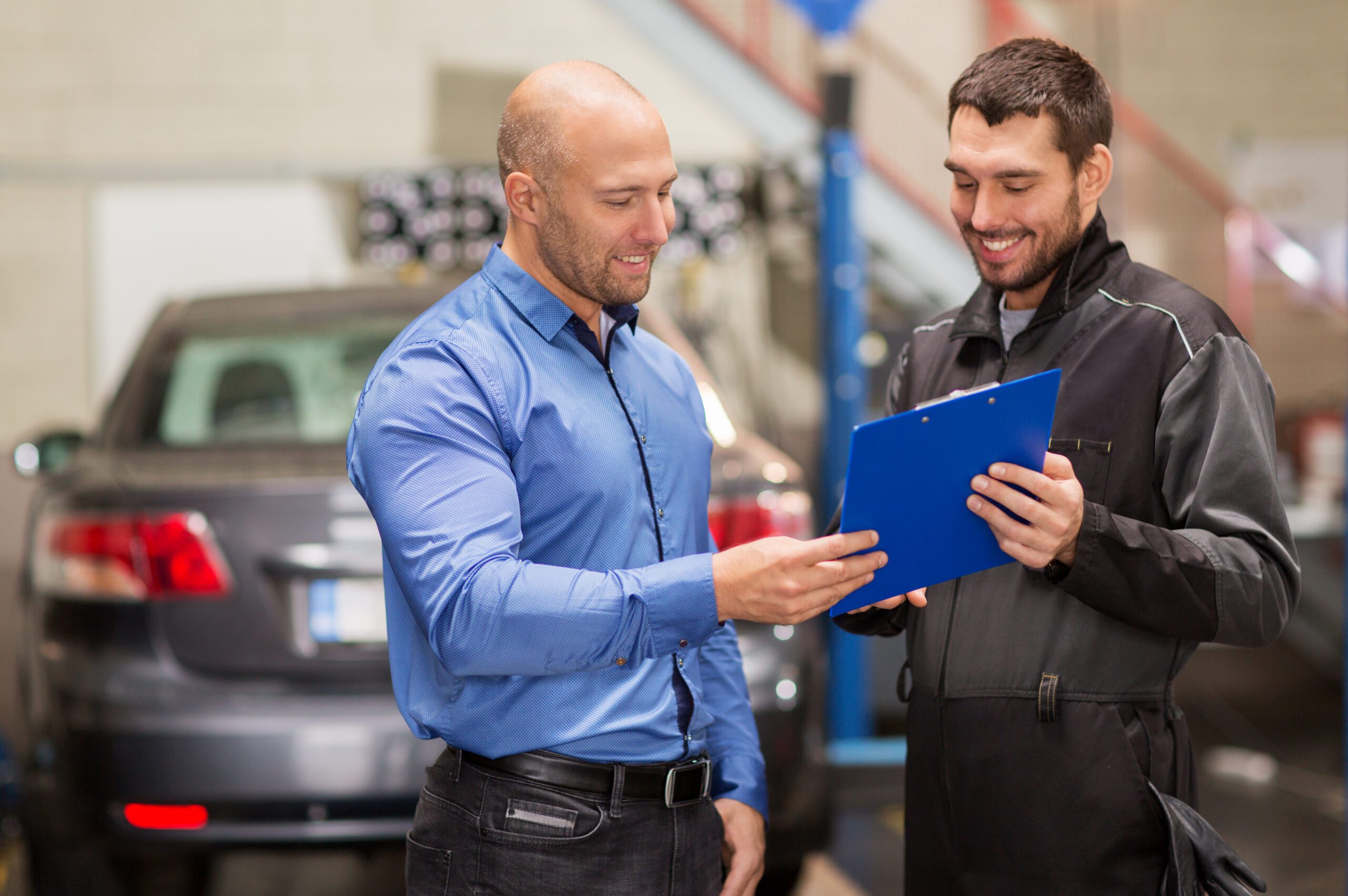 Mechanic with customer at workshop