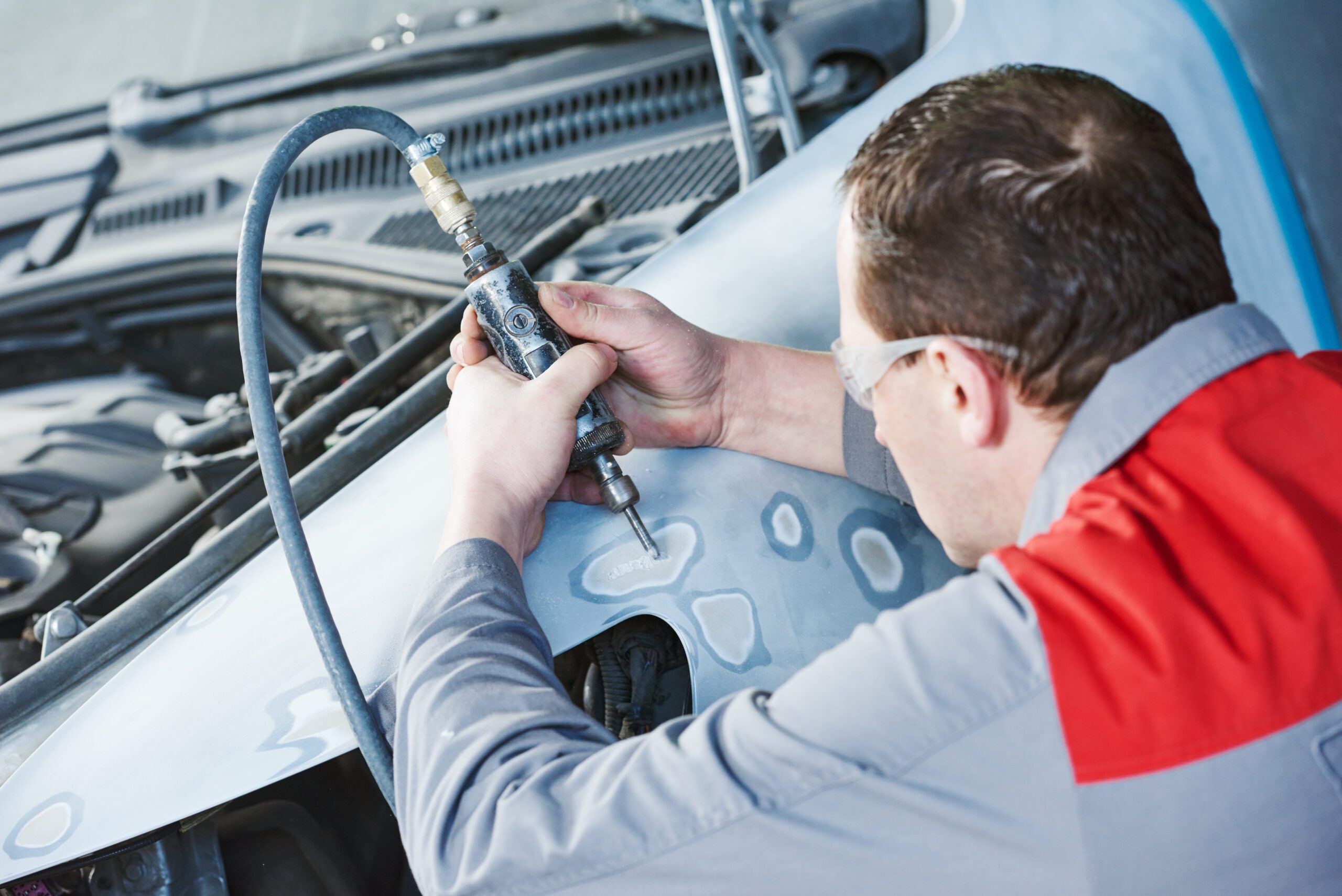 Auto mechanic repairing car